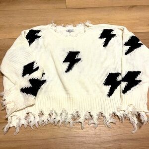 Cream sweater with lightening bolts.